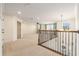 Upstairs loft featuring carpet, ample natural light, and wrought iron railing at 19209 Long Lake Ranch Blvd, Lutz, FL 33558