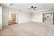 Spacious main bedroom featuring a ceiling fan, with views to a luxurious bathroom and the upper hallway at 19209 Long Lake Ranch Blvd, Lutz, FL 33558