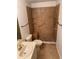 Bright bathroom featuring a tiled walk-in shower with a bench and updated fixtures at 1922 Blue Sage Ct, Brandon, FL 33511