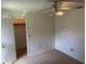 This bedroom offers a ceiling fan with lights and an open closet at 1922 Blue Sage Ct, Brandon, FL 33511