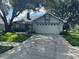 Charming single Gathering home with mature trees, well-manicured lawn, and two car garage at 1922 Blue Sage Ct, Brandon, FL 33511