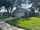 Exterior of home with a paved driveway, lawn, and shrubs at 1922 Blue Sage Ct, Brandon, FL 33511
