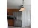 The kitchen features stainless steel appliances and ample cabinet space with a light fixture above at 1922 Blue Sage Ct, Brandon, FL 33511