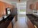 Kitchen featuring stainless steel appliances, granite countertops, and a view to the fenced in backyard at 1922 Blue Sage Ct, Brandon, FL 33511