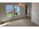 Bright living room featuring large windows, plush carpet, chandelier, and views to adjacent rooms at 1922 Blue Sage Ct, Brandon, FL 33511