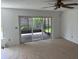 This bright living room features patio access and plush carpets at 1922 Blue Sage Ct, Brandon, FL 33511
