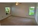 Spacious main bedroom with a ceiling fan and two windows letting in natural light at 1922 Blue Sage Ct, Brandon, FL 33511