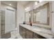 Bathroom with double vanity, gray cabinetry, granite countertops, and modern fixtures at 1976 Marlington Way, Clearwater, FL 33763