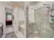 Bathroom showcasing tile shower with glass door, soaking tub, and vanity with countertop at 1976 Marlington Way, Clearwater, FL 33763