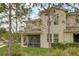 Exterior view of home featuring screened lanai and lush landscaping at 1976 Marlington Way, Clearwater, FL 33763