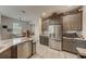 Well-lit kitchen with stainless steel appliances, granite countertops, tile backsplash, and adjacent dining area at 1976 Marlington Way, Clearwater, FL 33763