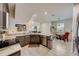 Open kitchen with granite countertops, modern appliances, and a view of the dining area at 1976 Marlington Way, Clearwater, FL 33763