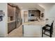 Well-equipped kitchen featuring stainless steel appliances, a breakfast bar, and a laundry area at 1976 Marlington Way, Clearwater, FL 33763