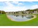 Scenic view of community pond with surrounding townhomes reflecting in the water at 1976 Marlington Way, Clearwater, FL 33763