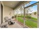 Relaxing screened porch with comfortable seating and a view of the beautifully landscaped lawn at 1976 Marlington Way, Clearwater, FL 33763