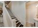 Elegant staircase with dark wood treads and white risers, leading to the upper level of the home at 1976 Marlington Way, Clearwater, FL 33763