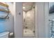 Bright bathroom featuring walk-in shower with glass door and marble tile at 2 Seaside Ln # 801, Belleair, FL 33756