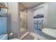 Modern bathroom featuring a glass shower, grey walls, marble floors, and a pedestal sink at 2 Seaside Ln # 801, Belleair, FL 33756