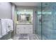 Modern bathroom featuring white vanity, large mirror, and frameless glass shower at 2 Seaside Ln # 801, Belleair, FL 33756