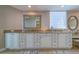 Elegant bathroom with spacious double vanities, framed mirrors, and natural light at 2 Seaside Ln # 801, Belleair, FL 33756