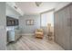 Bedroom showcasing a Murphy bed, cozy seating area, window, hardwood floors, and tasteful decorations at 2 Seaside Ln # 801, Belleair, FL 33756