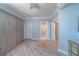 Bedroom with hardwood floors, Murphy bed, and an open doorway leading to the bathroom and walk-in closet at 2 Seaside Ln # 801, Belleair, FL 33756