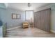 Bedroom featuring a comfortable chair, small table, and a Murphy bed, illuminated by natural light through the window at 2 Seaside Ln # 801, Belleair, FL 33756