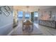 Bright dining room featuring water views, modern chandelier, glass table and stylish decor at 2 Seaside Ln # 801, Belleair, FL 33756