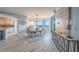 Bright dining room featuring water views and an elegant chandelier with nearby kitchen at 2 Seaside Ln # 801, Belleair, FL 33756