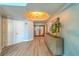 Inviting foyer with decorative doors, elegant lighting, and a stylish console table at 2 Seaside Ln # 801, Belleair, FL 33756