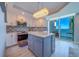 Modern kitchen showcasing a center island, granite countertops, and stainless steel appliances at 2 Seaside Ln # 801, Belleair, FL 33756