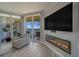 Cozy living room with modern fireplace and large sliding glass doors to the balcony with ocean view at 2 Seaside Ln # 801, Belleair, FL 33756