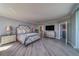 Spacious main bedroom featuring wood floors, TV, and decorative furnishings, with ensuite bathroom at 2 Seaside Ln # 801, Belleair, FL 33756