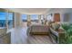 Inviting main bedroom boasts water views, wood floors, and comfortable seating area at 2 Seaside Ln # 801, Belleair, FL 33756