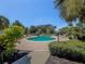 Community pool surrounded by lush landscaping, lounge chairs, and inviting atmosphere at 2 Seaside Ln # 801, Belleair, FL 33756