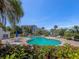 Community pool offering multiple seating areas and a relaxing atmosphere under a sunny sky at 2 Seaside Ln # 801, Belleair, FL 33756