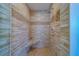 Walk-in shower featuring neutral tile work, built-in bench and a coordinated mosaic accent strip at 2 Seaside Ln # 801, Belleair, FL 33756