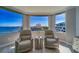 Charming interior sitting area with stunning water views, comfortable chairs, and natural light at 2 Seaside Ln # 801, Belleair, FL 33756