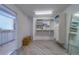 Spacious walk-in closet featuring built-in storage, shelves for linens, a full-length mirror, and access to the bathroom at 2 Seaside Ln # 801, Belleair, FL 33756