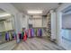 Large walk-in closet featuring ample shelving, hanging storage, and a full-length mirror, with access to the bathroom at 2 Seaside Ln # 801, Belleair, FL 33756