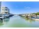 Beautiful water view of docks and docked boats alongside a condo building under a clear sky at 2 Seaside Ln # 801, Belleair, FL 33756