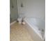 Bathroom with a soaking tub, a separate shower, and neutral tile flooring at 21544 Clubside Loop, Lutz, FL 33549