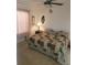 Bedroom featuring a cozy quilt, neutral carpet, and a decorative window at 21544 Clubside Loop, Lutz, FL 33549