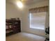 Bedroom featuring neutral carpet, a ceiling fan, and a large window at 21544 Clubside Loop, Lutz, FL 33549