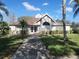Community clubhouse showcasing a well manicured lawn and manicured shrubs at 21544 Clubside Loop, Lutz, FL 33549