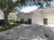 Charming single-story home with a well-maintained lawn and attached one-car garage at 21544 Clubside Loop, Lutz, FL 33549
