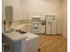 Bright kitchen features white appliances, ample counter space, and vinyl flooring at 21544 Clubside Loop, Lutz, FL 33549