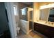 Modern bathroom with a glass-enclosed shower, dark wood vanity, and ample storage at 2575 W Platt St, Tampa, FL 33609