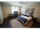 Well-lit bedroom with a cozy bed, home office setup, and stylish decor at 2575 W Platt St, Tampa, FL 33609