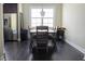 Well-lit dining area featuring a wooden table with cushioned chairs and a view of stainless steel appliances at 2575 W Platt St, Tampa, FL 33609